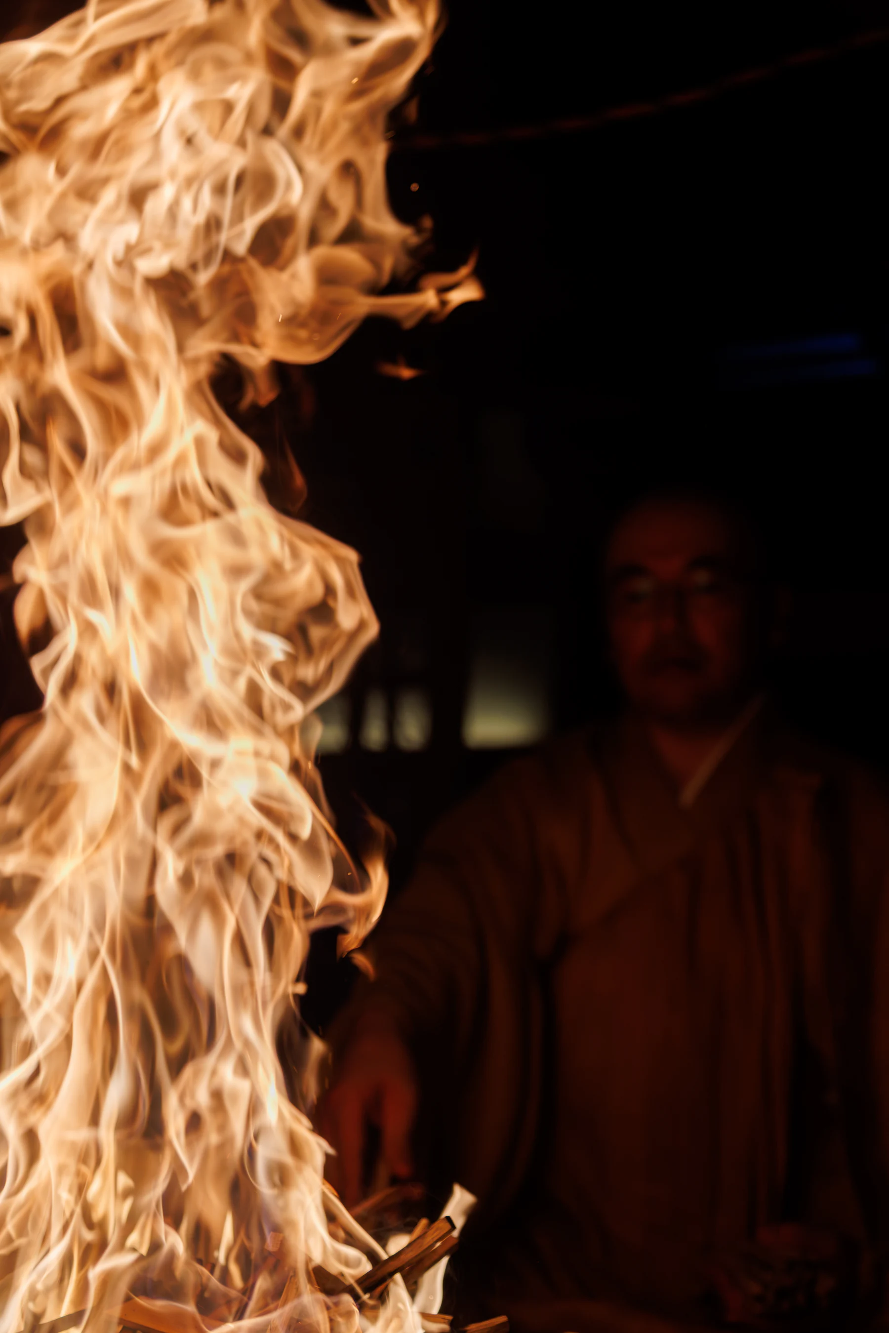 The priest performing the goma beyond the flames