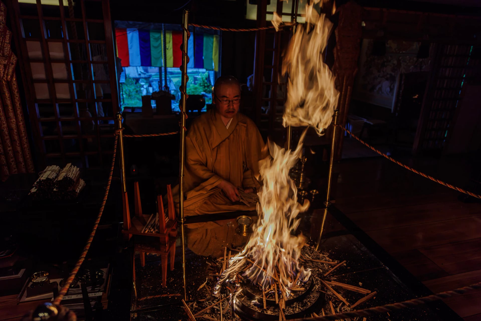 The priest offering goma sticks at the altar